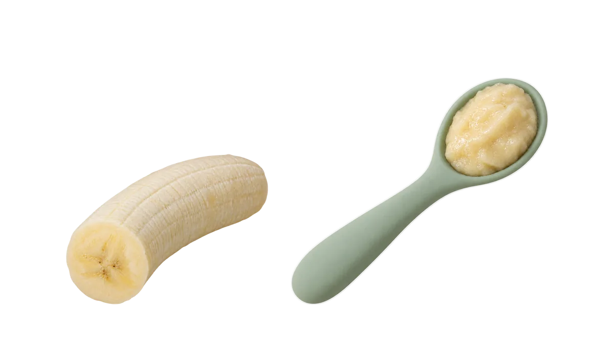 Banana at 6 months: half a peeled banana to hold in a fist, and mashed banana on a preloaded spoon
